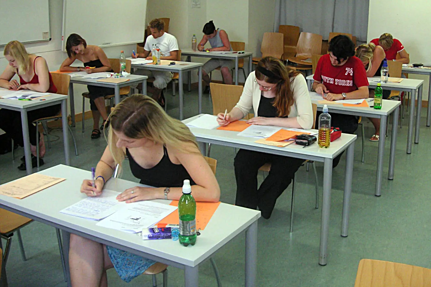 Students sitting an examination for an IB retake guide