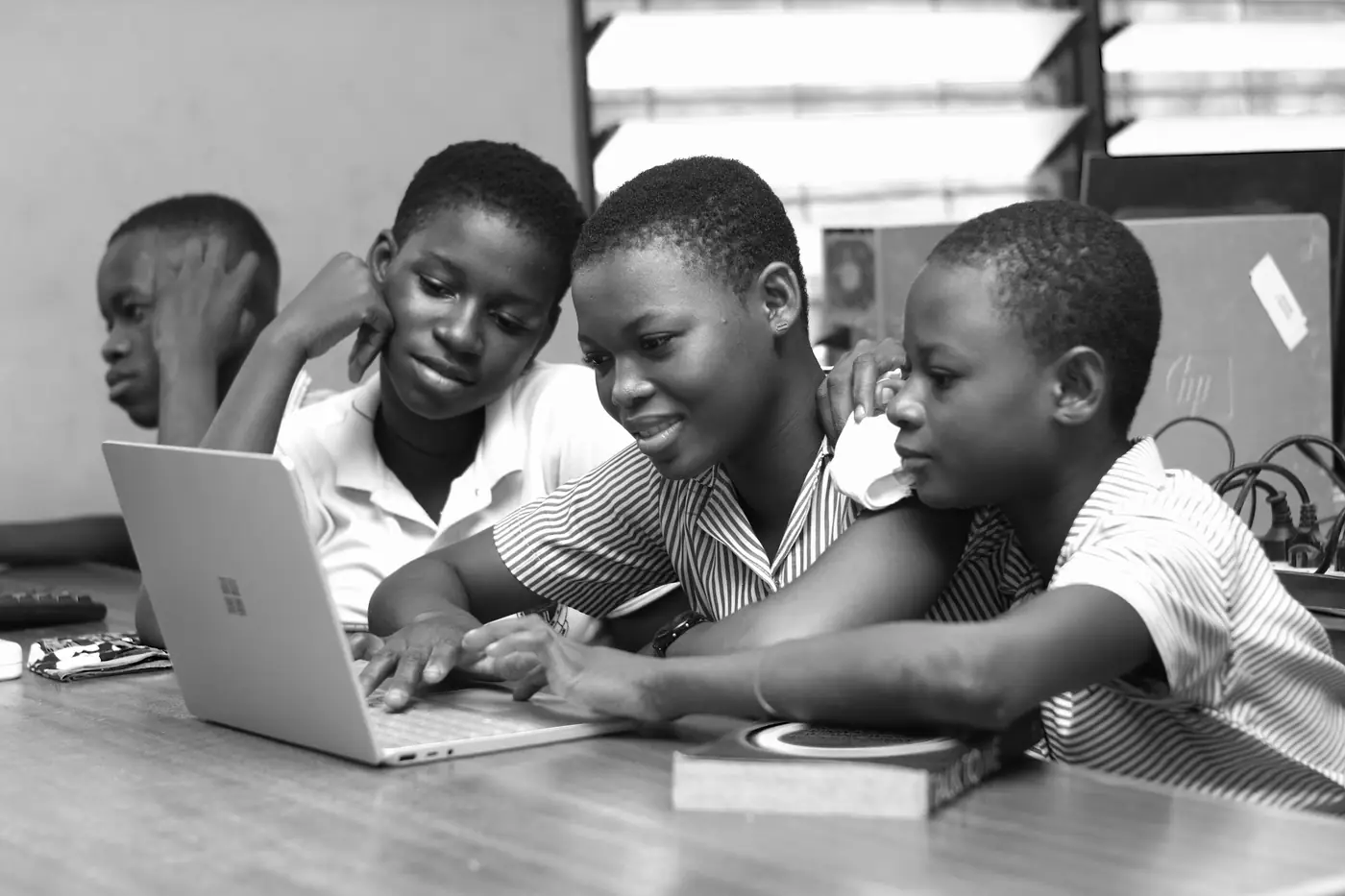Students using a laptop to access the IB candidate website