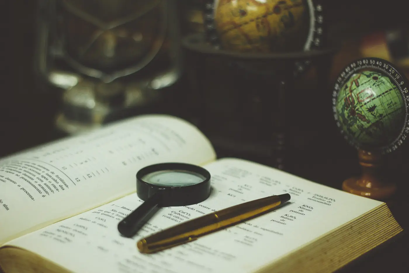 Books and magnifying glass for comparing IB EUR categories