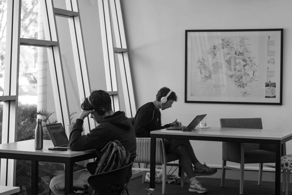 Students studying with laptops in a quiet study room